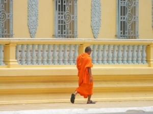 Monk walking in front of Royal Palace