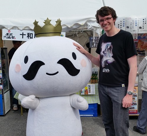 James Lomonosoff with a mascot in Aomori, Japan