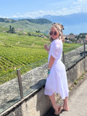 A girl in a winery in a white sundress