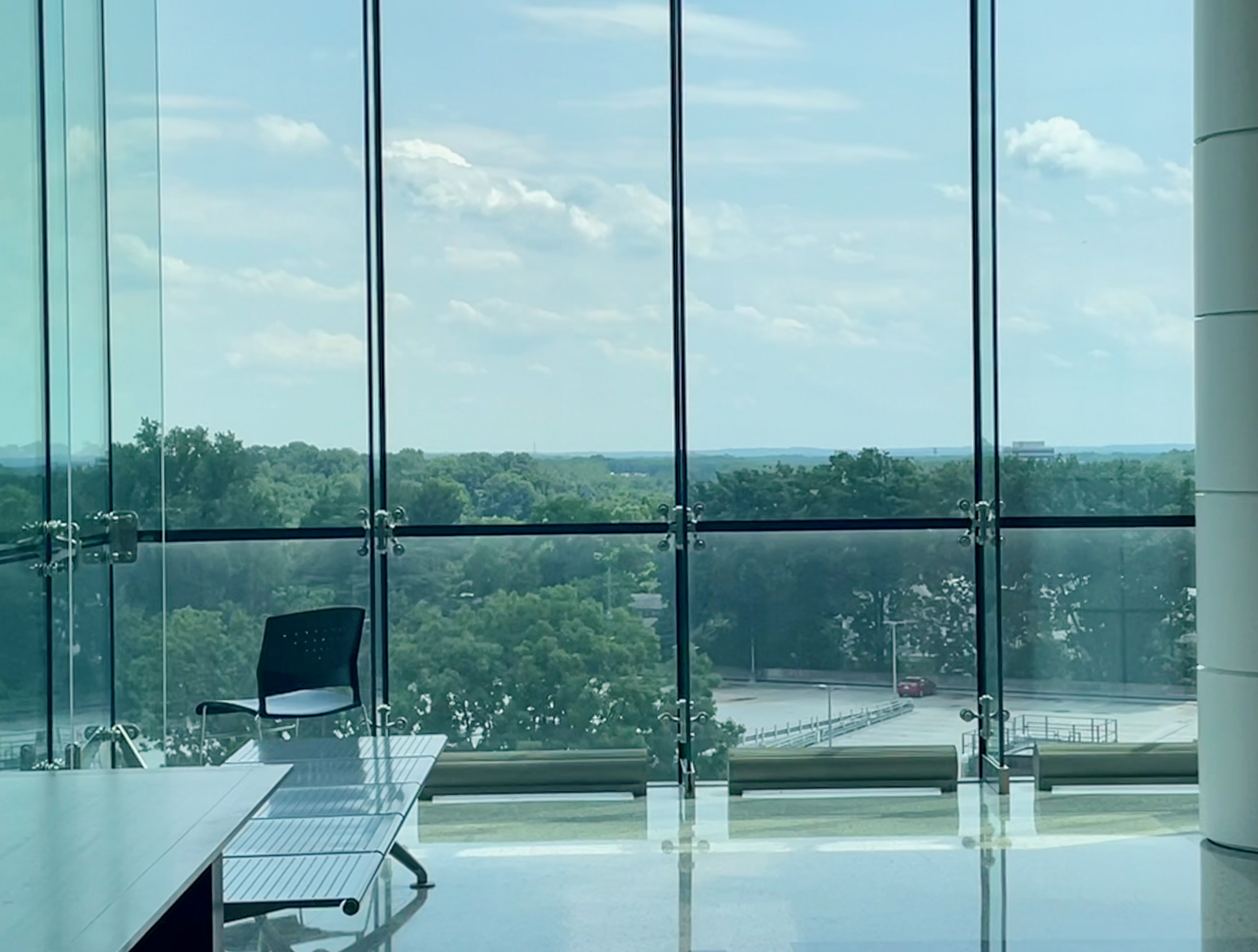 Large floor-to-ceiling windows overlooking a verdant view from the Montgomery County Courthouse.