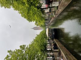 A view of a canal in Delft with a church in the background