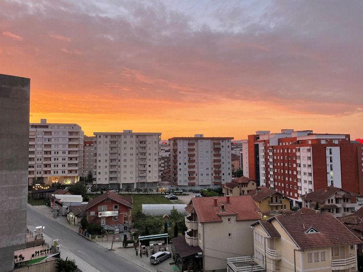 A colorful sunrise over a city skyline.