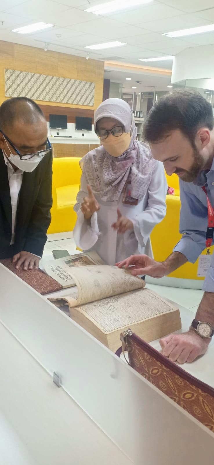 Examining 15th century legal texts at the Indonesian National Library Rare Book floor.