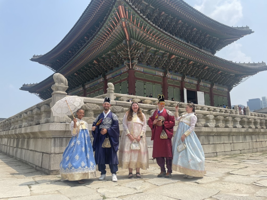 Lily, Mecca, and I and two also dressed up strangers in front of the Gyeongbokgung Palace