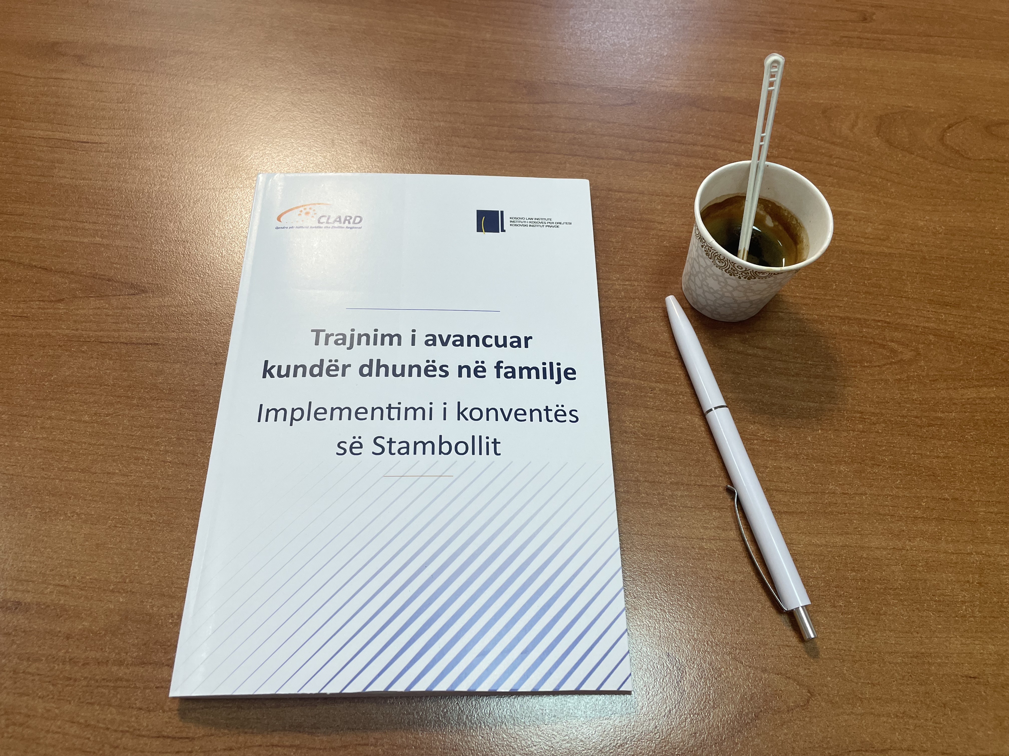 From CLARD's training at the Academy of Justice: a book with a title in Albanian that translates to "Advanced Training Against Domestic Violence, Implementation of the Istanbul Convention," a pen, and an espresso.