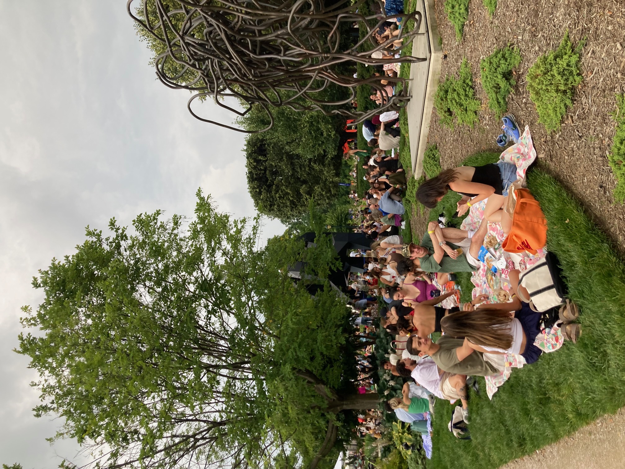 People listening to jazz in the sculpture garden.