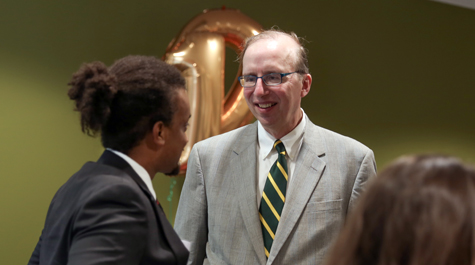 During the first day of Law Week every August, Dave Douglas has been on hand to welcome each new student personally and present them with a William & Mary Law cap. (Photo by David Morrill)