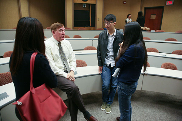 Professor Rosenberg meets with students after class.