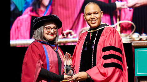 Professor Giuffrida received the John Marshall Award from Dean A. Benjamin Spencer during the Law School’s commencement ceremony on May 18.  