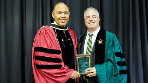 Wall received the Walter L. Williams, Jr. Memorial Teaching Award from Dean A. Benjamin Spencer during the Law School's commencement ceremony on May 18.