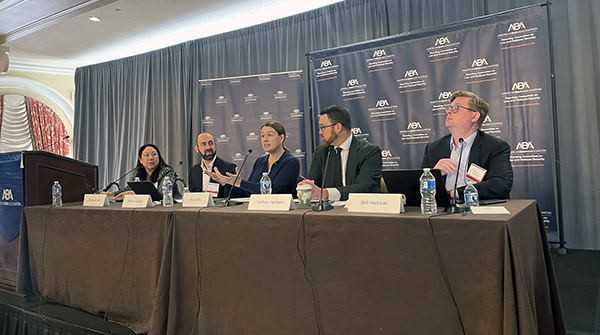 Professor Hu (left) moderated a panel on "The AI Arms Race and National Security Law." 