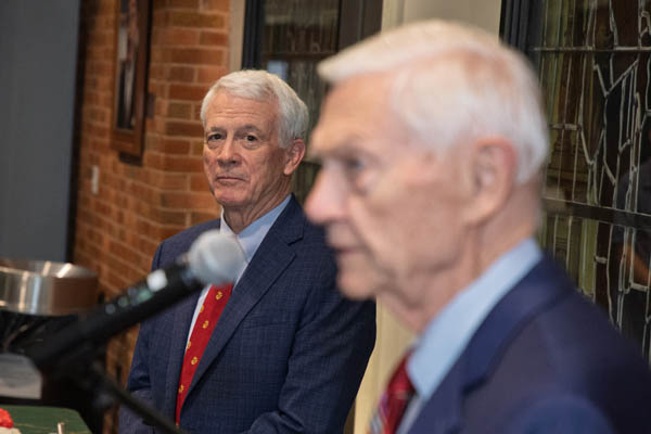 Mike Dick listens as William & Mary President Emeritus Taylor Reveley speaks at the cording ceremony.