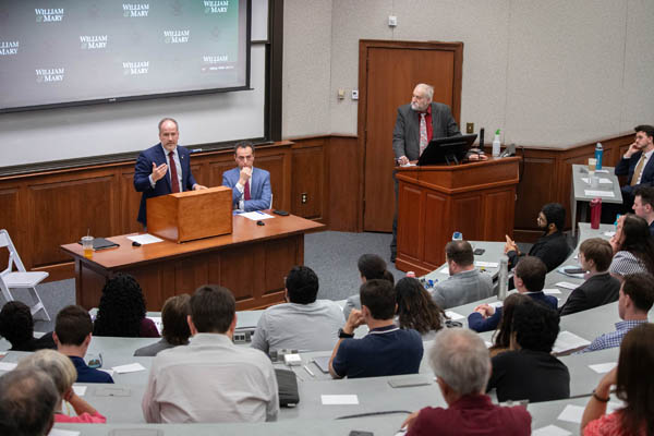 During the debate, Delegate Marcus Simon and moderator Dwayne Yancey listened as Brian Cannon (left) raised concerns about potential unintended consequences of altering the system voters approved in 2020.