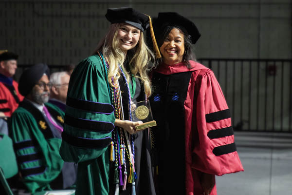 Emma Davis Herber received the I’Anson Award from Vice Dean Kami Chavis during Commencement on May 16.