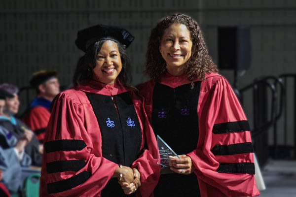 Vivian Hamilton received the John Marshall Award from Vice Dean Kami Chavis during the Law School’s commencement ceremony on May 16.