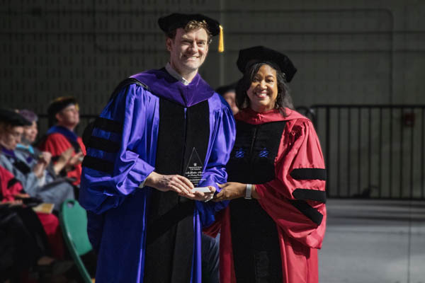 Professor Bruhl received the McGlothlin Award from Vice Dean Kami Chavis during the Law School's commencement ceremony on May 16.