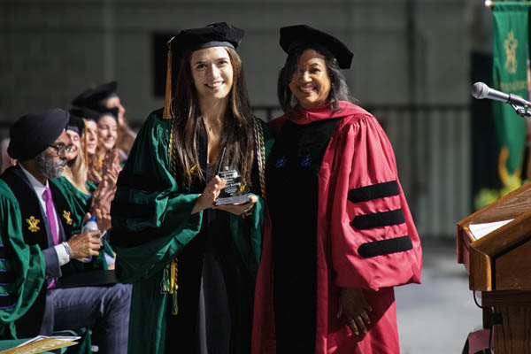 Rustom received the Thurgood Marshall Award from Vice Dean Kami Chavis during Commencement.