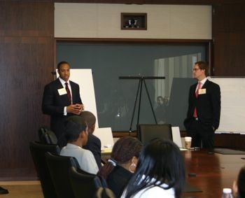 Walter Thompson, at left, and Ted Elmore review key terms in contracts and negotiation at the start of the April workshops and career fair at Hunton & Williams.